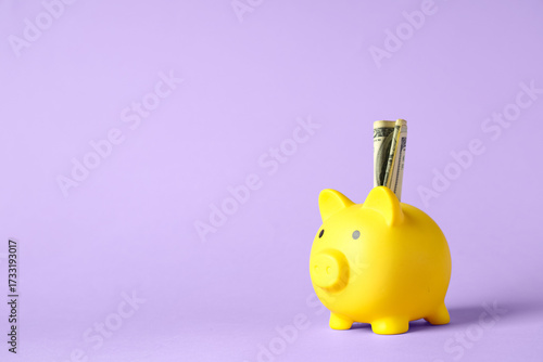 Yellow piggy bank with doll...