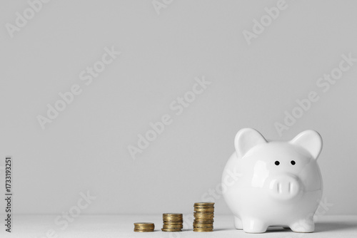 White piggy bank with coins...