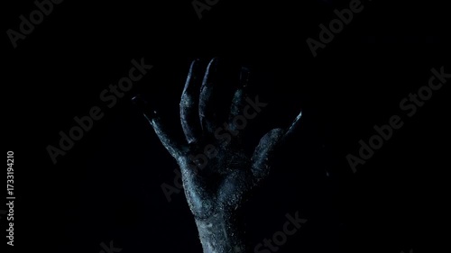 Shadow of a zombie hand on black background
