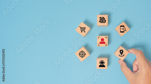 Billede på lærred senior businessman's hand hold check in icon on wooden cube block people inside