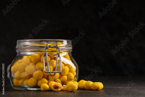 Jar with cheese coated pean...