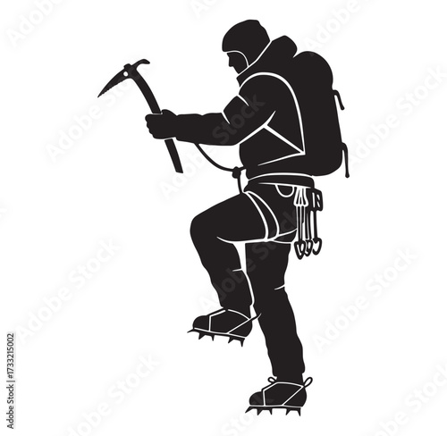 Silhouette of a mountaineer equipped for climbing with ice axe and backpack ascending
