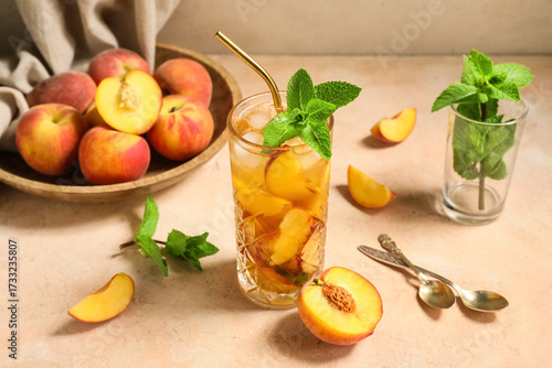 Glass of tasty peach iced t...