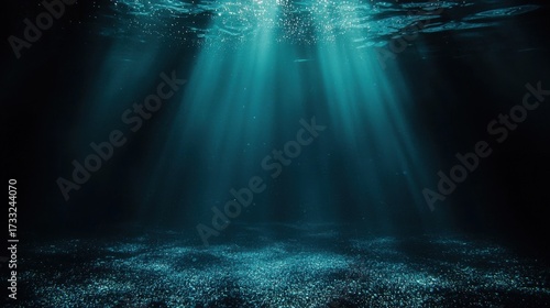Underwater scene with sunlight beams piercing deep blue water,