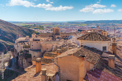 Cuenca cityscape with tiled roofs and cathedral towering over old town in spain