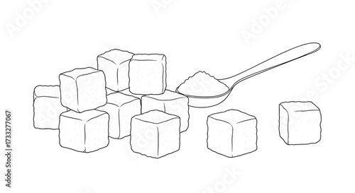 A spoonful of sugar is being scooped from a pile of sugar cubes.  