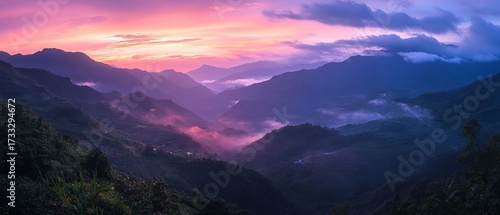 Panoramic mountain range at vibrant sunrise/sunset
