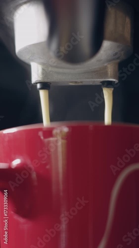 Pouring coffee stream from machine in cup. Home making hot Espresso. Using filter holder. Flowing fresh ground coffee. Drinking roasted black coffee in the morning. Home made. 4k b-roll.