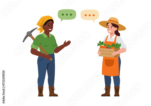 Two diverse female farmers having a conversation, one holding a pickaxe and the other a crate of fresh carrots.