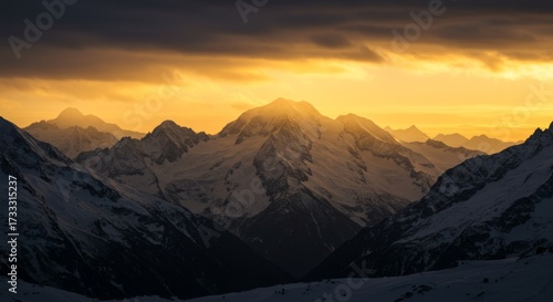 Snowy peaks bathed in golden sunset light