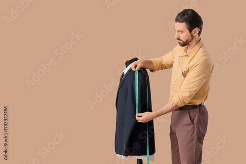 Male tailor measuring jacke...