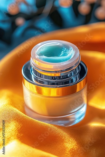 Cosmetic cream jar on satin, warm light