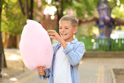 Teen boy eating cotton cand...
