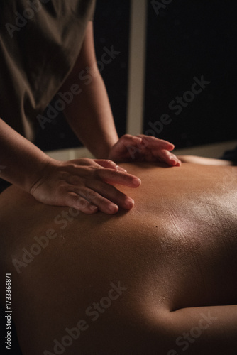 Close-up of hands performing relaxing massage therapy in a spa setting. Manual body treatment for stress relief, relaxation, and holistic wellness.
