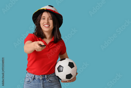 Young woman with TV remote ...