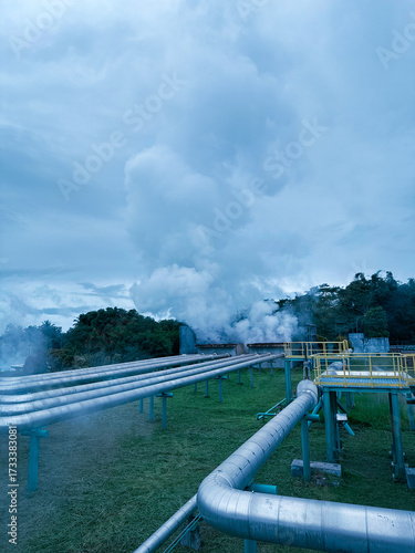 Geothermal power plant in North Sulawesi, Indonesia with steam, energy, power generation. Industrial architecture in landscape, renewable industry, sustainable energy.