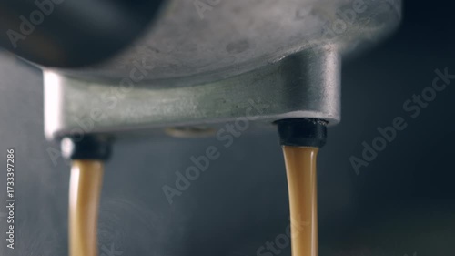 Pouring coffee stream from machine in cup. Home making hot Espresso. Using filter holder. Flowing fresh ground coffee. Drinking roasted black coffee in the morning. Home made. 4k b-roll.