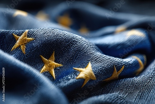 Close-up of european union flag showing detailed embroidery and stitching, golden stars set against a blue background with fabric texture creating soft folds