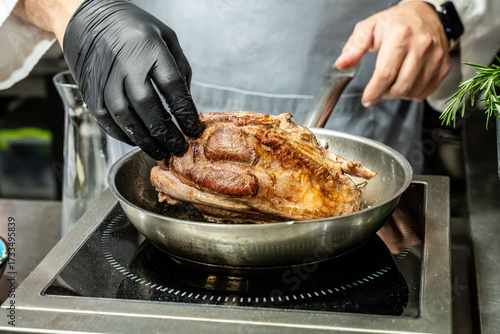 Chef searing meat in pan