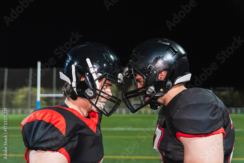 Canvas-taulu American football players in helmets and shoulder pads facing each other intense