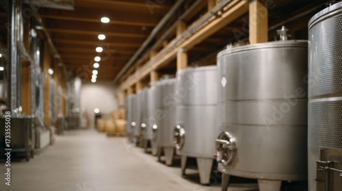 Stainless steel wine tanks glimmer under industrial lights, echoing harvest festivals and vinification ceremonies, evoking vintage elegance