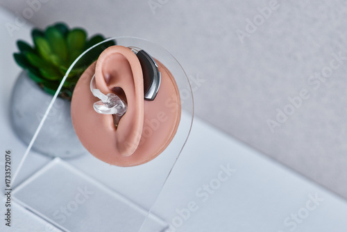 Behind-the-ear hearing on real ear anatomical model, highlighting auditory health and solutions. Hearing health