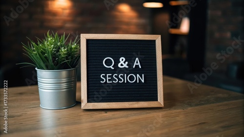 Wooden framed Q and A session message on a wooden surface