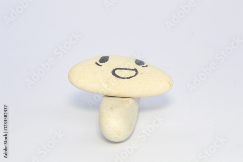 white pebble Stone with Smiling Face Cartoon. Serene, Balancing Body, Mind, Soul and Spirit. Mental Health Practice