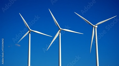 Three white wind turbines against a vibrant blue sky (4)