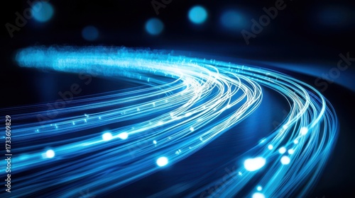 Curved beam paths illuminated optical fibers flowing in sweeping arcs against deep blue background with bright light points