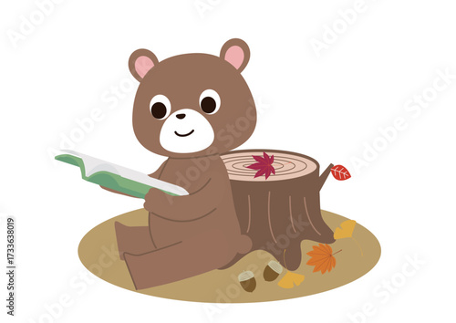切り株のそばで読書しているクマさん