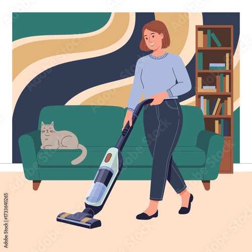 Woman vacuuming with a cordless vacuum cleaner in a living room with a cat cleaning