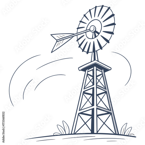Old-fashioned windmill with spinning blades and grass