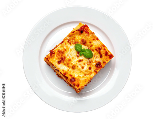 A square portion of lasagna on a white plate, topped with basil