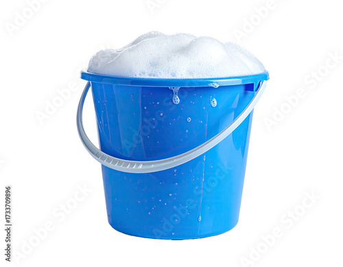 A blue plastic bucket overflowing with bubbly, white soap suds against black background