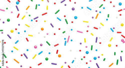 Colorful sprinkles scattered across a white background, creating a festive pattern.