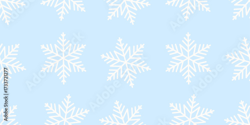 Seamless winter pattern with white snowflakes on light blue background. Perfect for Christmas design, festive wrapping paper, textiles, and seasonal decoration