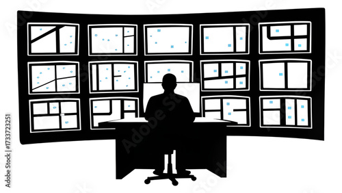 Silhouette of person at desk facing wall of monitors displaying city maps and location markers visible