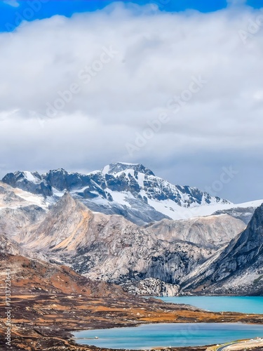 Towering Snowcapped Alpine Peaks Over Turquoise Mountain Lakes in Dramatic Wilderness Landscape