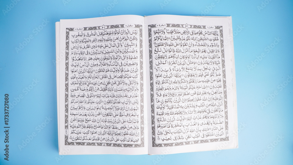 Obraz premium Open Quran book on blue background with copy space