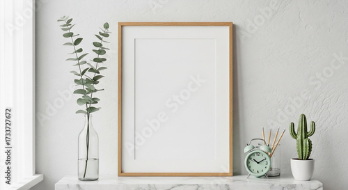 Blank picture frame on shelf with plants