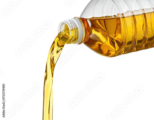 A clear plastic bottle is angled, pouring golden liquid against a black background