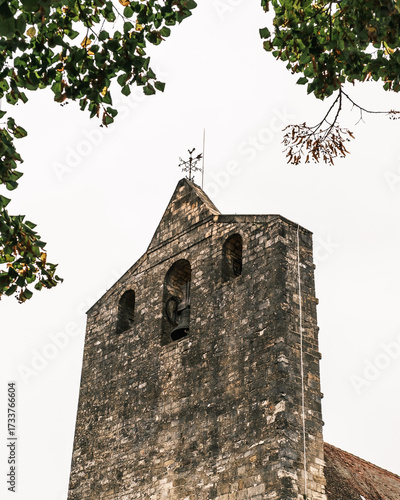 The bell tower at the Eglise catholique Notre-Dame-de-l'Assomption in the bastide village of Domme in the Dordogne region of France
