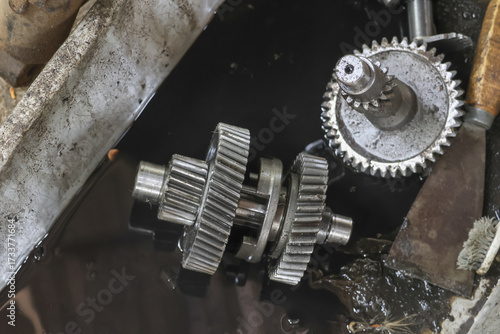 Close up mechanical gears, showing wear and tear, with sense of mechanical complexity and industrial application, evoking feeling of ruggedness and functionality