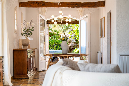 Bright Mediterranean living room with rustic beams and garden view