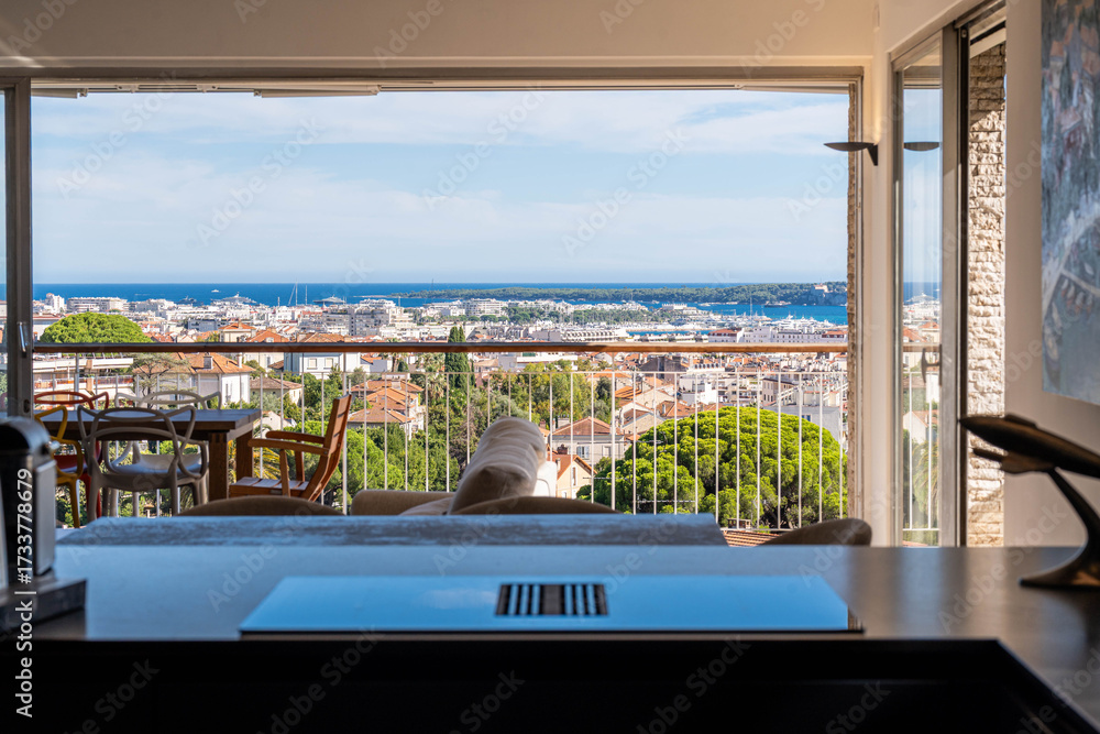 Fototapeta premium Modern apartment workspace with panoramic view over Cannes and the sea