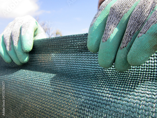    Dark green shade netting texture pattern. Used in gardening, nurseries and agriculture.                            