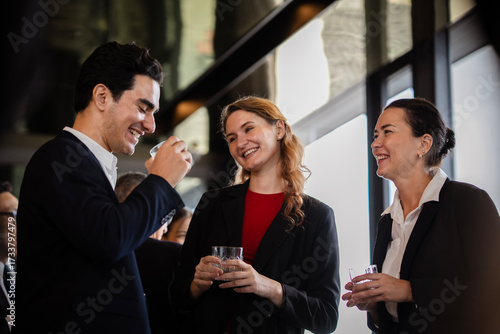 Business professionals combining work discussions or chitchat with leisure at a casual networking event, showcasing teamwork and relationship building.