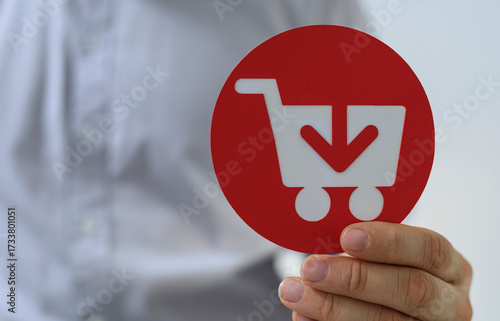 Hand holding red circle wit...
