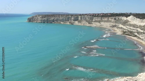 Stunning aerial footage of Zapalo Beach in Cyprus, showcasing turquoise waters, gentle waves, and pristine shoreline from above, capturing the natural beauty of the Mediterranean coast